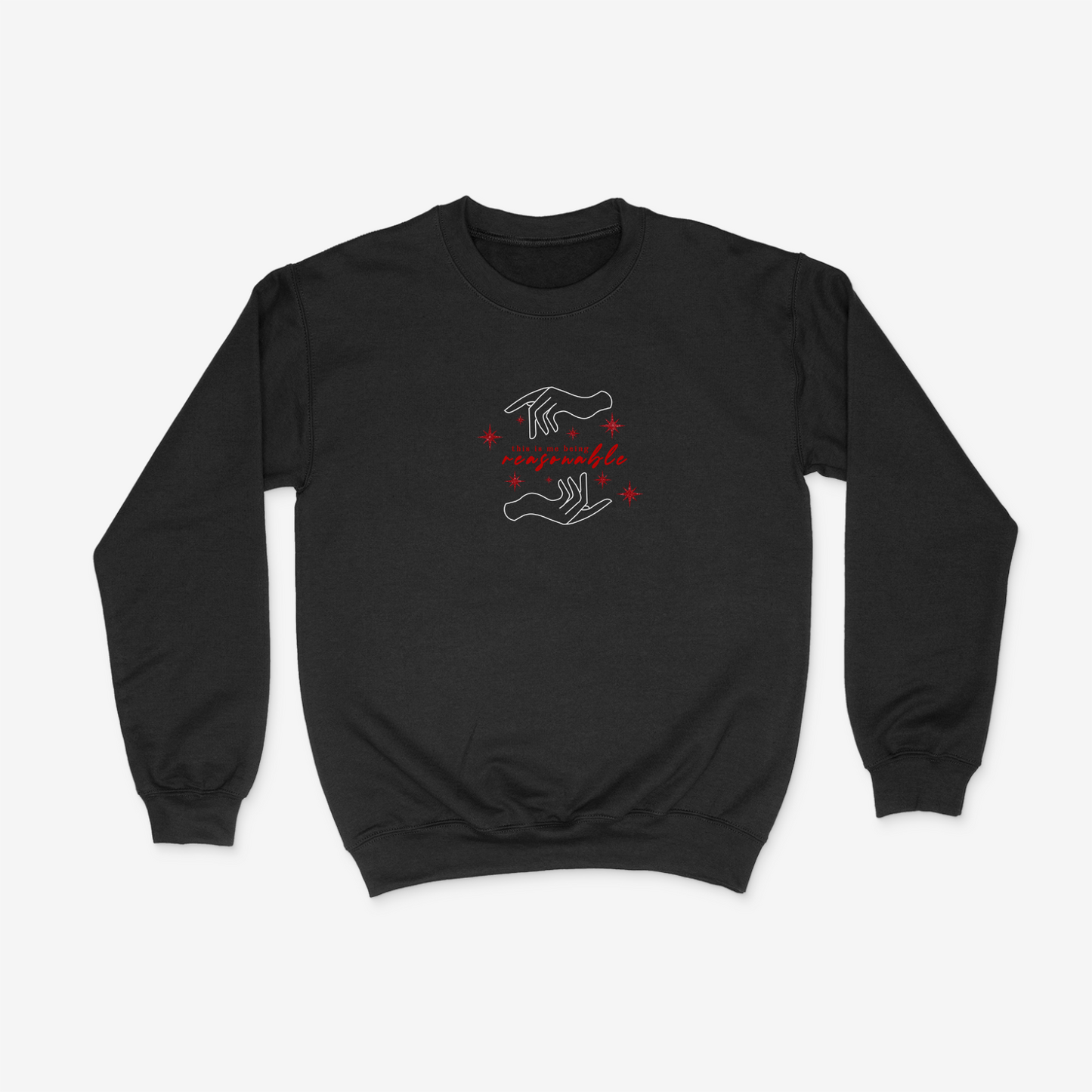 Black crewneck sweater featuring hand design, sparkly red stars, and the phrase "This is me being resasonable" .