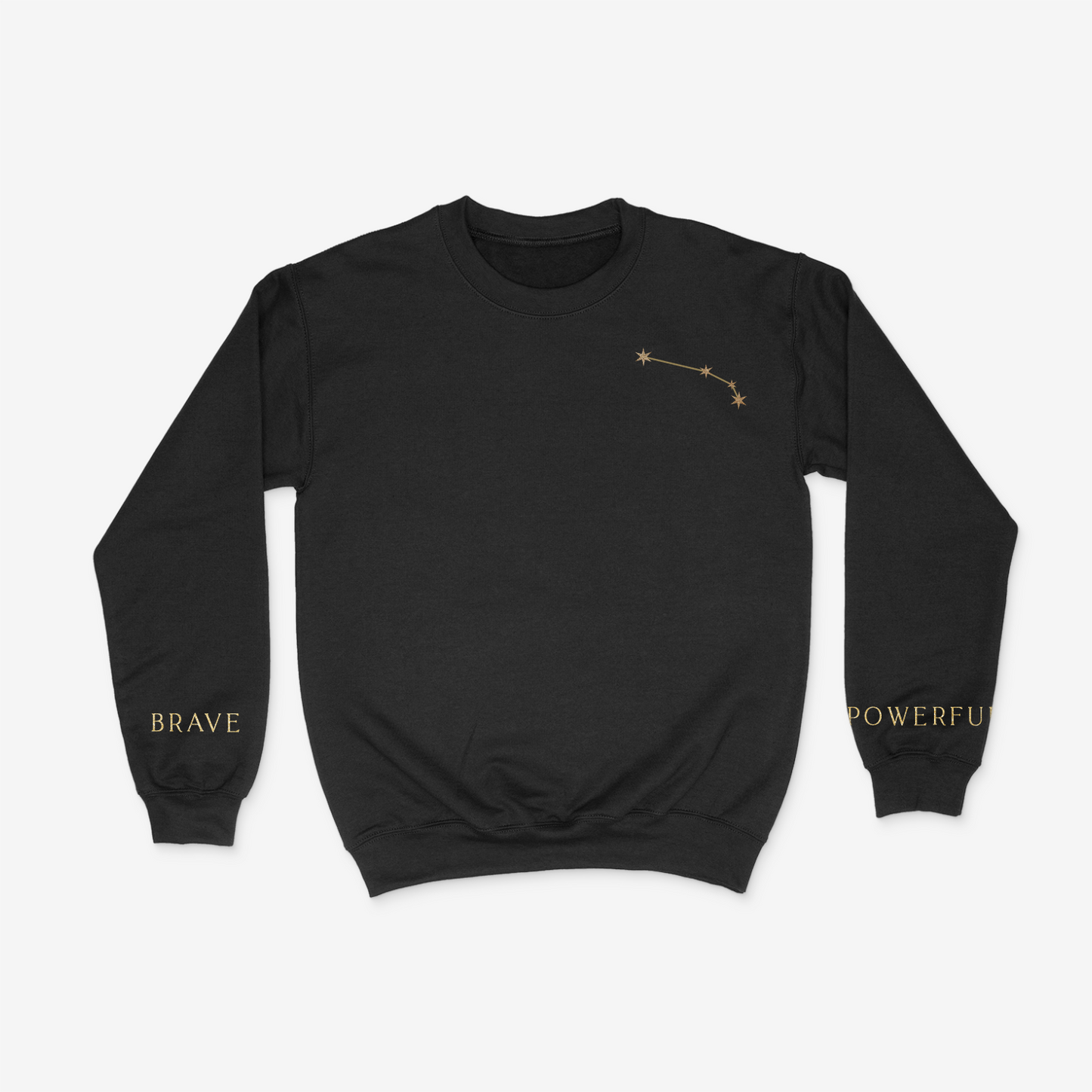 Black crewneck sweater with gold aries constellation on upper right chest pocket area and "brave" and "powerful" written on the wrists of either sleeve