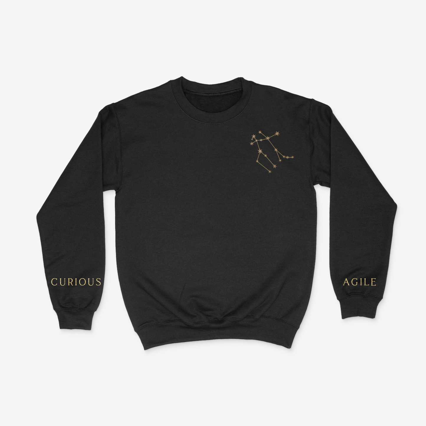 Black crewneck sweater with gold gemini constellation on upper right chest pocket area and "curious" and "agile" written on the wrists of either sleeve