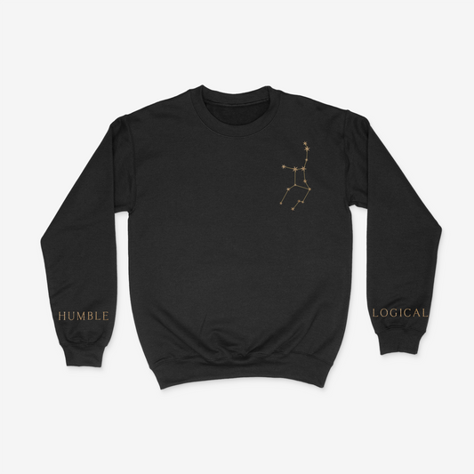 Black crewneck sweater with gold Virgo constellation on upper right chest pocket area and "humble" and "logical" written on the wrists of either sleeve